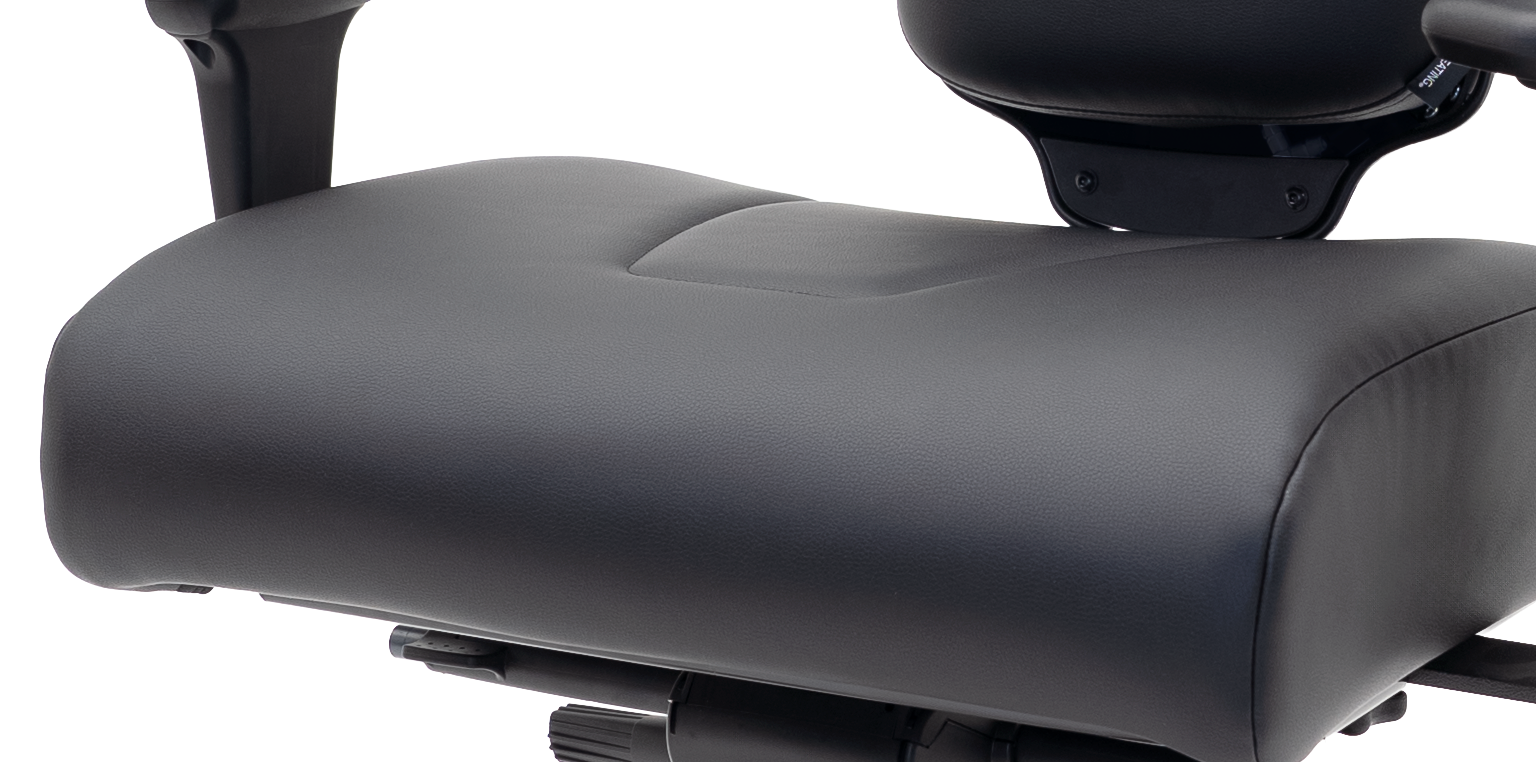 A close-up of the seat of an Concept Seating ergonomic chair with black leather upholstery.
